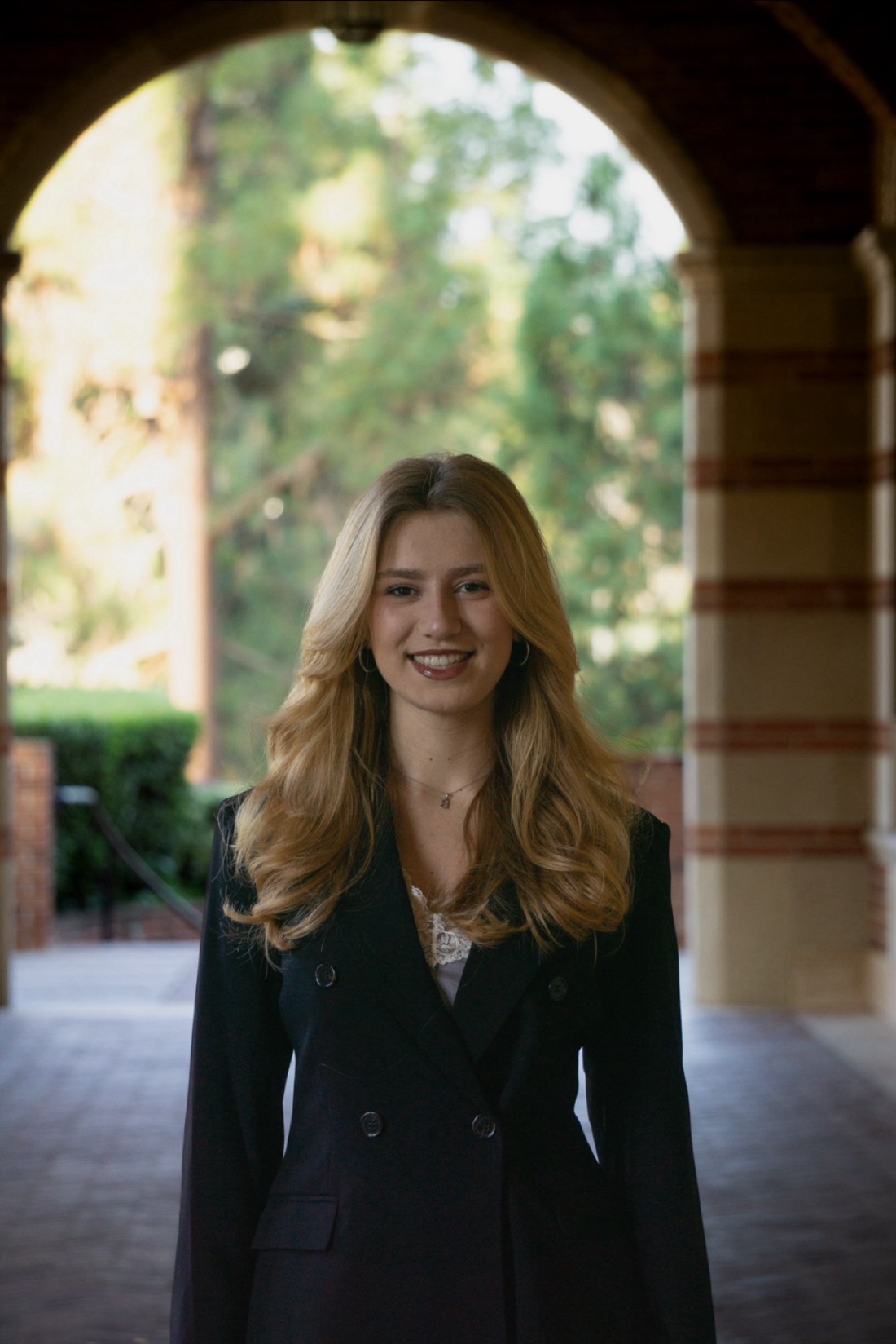 Kiersten Roth, standing under an archway on the UCLA campus.